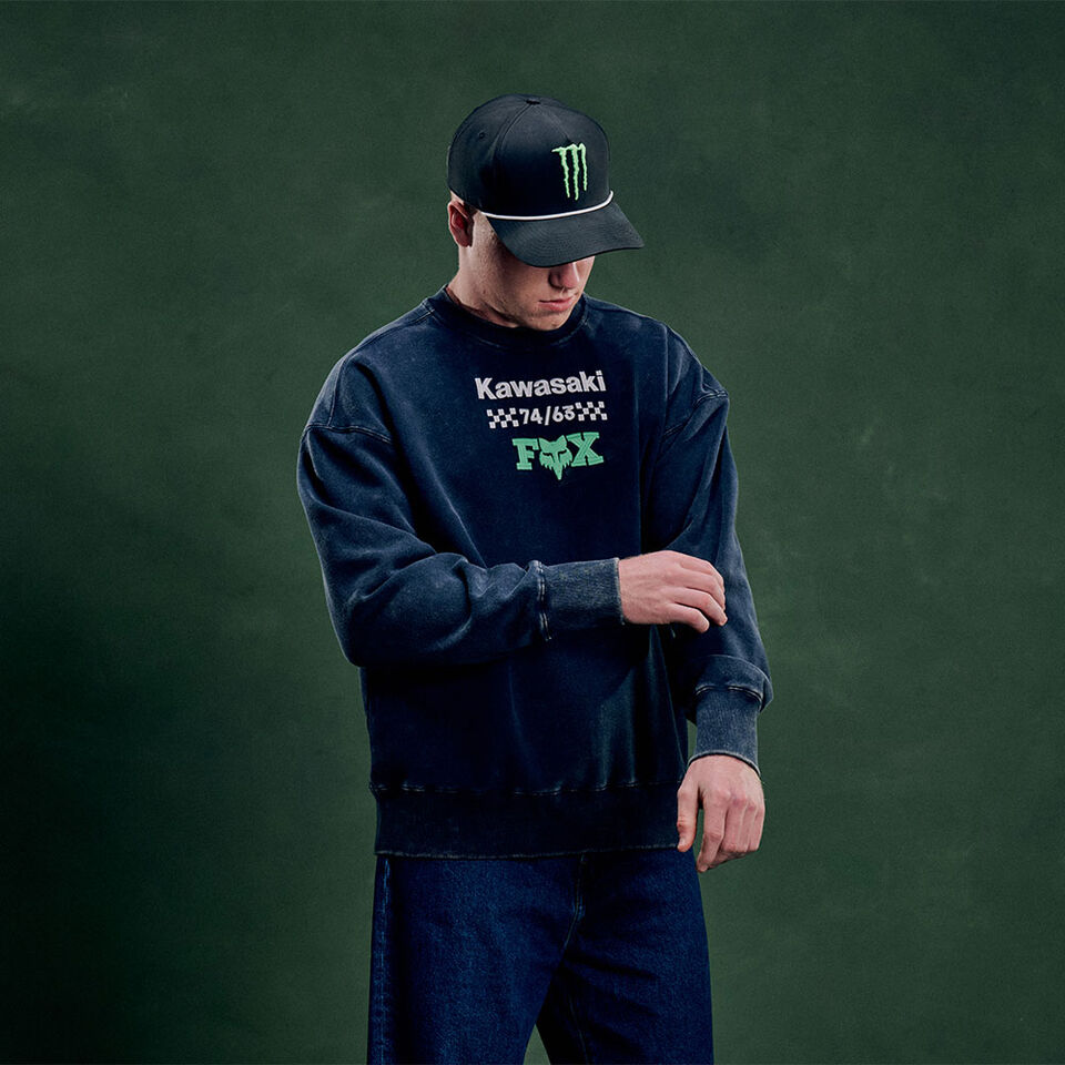 Rider in the air on a mx racetrack with Fox x Kawasaki Gear