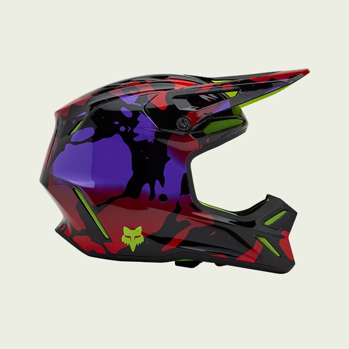 purple, red, and black v3 helmet on green background