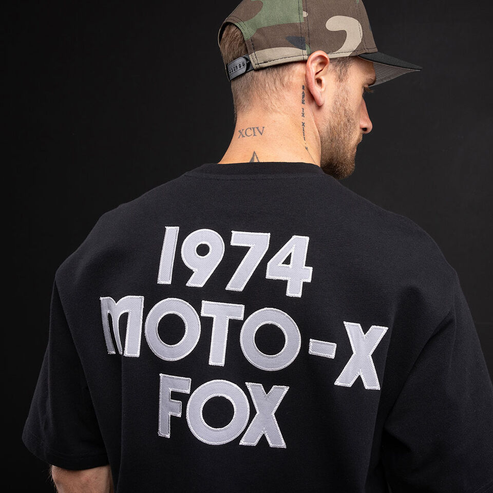 Person facing back with a Fox tee