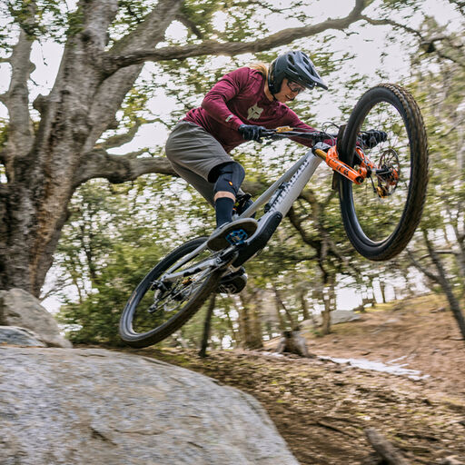 Mtb rider taking a jump off a rock