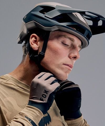 Close up of model putting on helmet