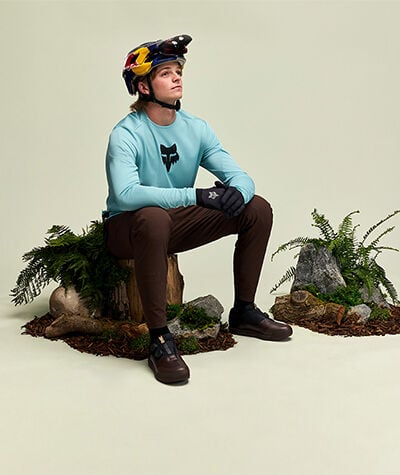 athelete in fox gear sitting on a log