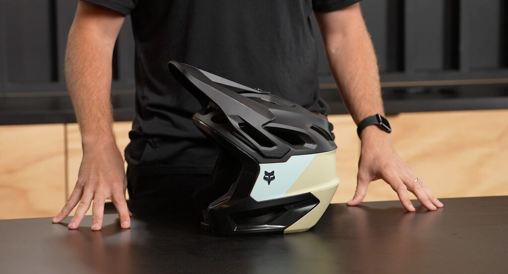 Man holding a Crossframe Pro helmet