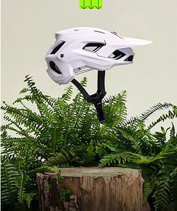Speedframe bike helmet floating with vegetation in the back
