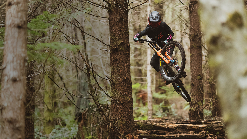 Fox Rider Jackson Goldstone Jumping off a Log on his Mountain Bike
