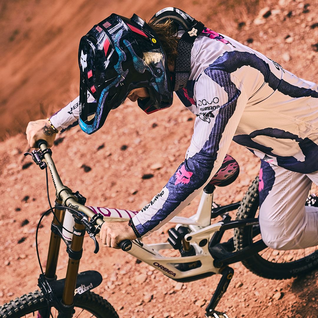 Rider pushing MTB up hill